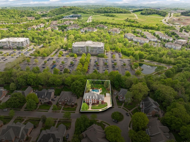 drone / aerial view featuring a residential view and a water view