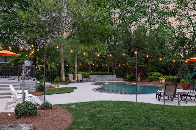 outdoor pool featuring a patio and a yard