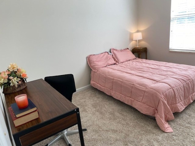 carpeted bedroom with baseboards