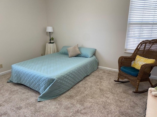 carpeted bedroom featuring baseboards