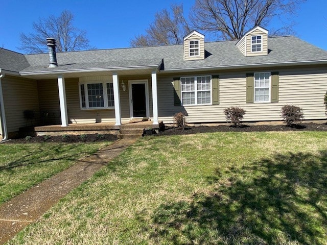 view of front facade with a porch, a shingled roof, and a front yard