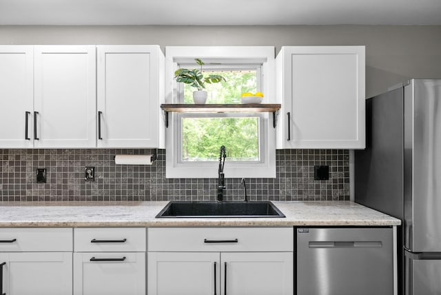 77 Deepwood Est, Cadiz, KY 42211 - kitchen with white cabinetry, tasteful backsplash, light stone counters, a sink, and appliances with stainless steel finishes