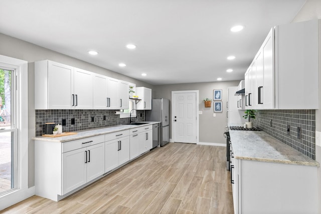 77 Deepwood Est, Cadiz, KY 42211 - kitchen with a sink, tasteful backsplash, light wood-style floors, and white cabinetry
