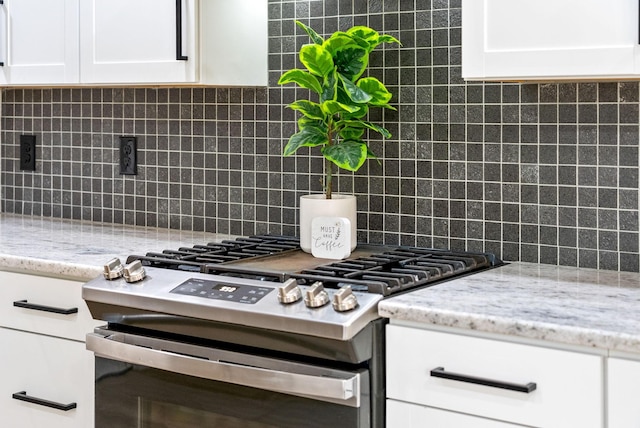 77 Deepwood Est, Cadiz, KY 42211 - kitchen featuring stainless steel range with gas cooktop, white cabinetry, light stone countertops, and tasteful backsplash