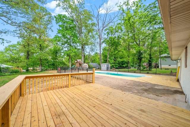 77 Deepwood Est, Cadiz, KY 42211 - deck with fence, a shed, a fenced in pool, a playground, and an outbuilding