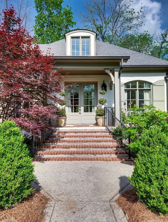 6553 Stableford Ln, Franklin, TN 37069 - view of exterior entry featuring a shingled roof, french doors, and covered porch