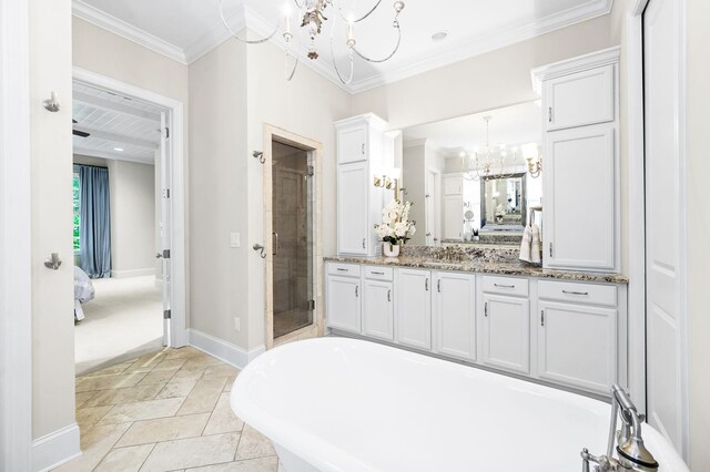 6553 Stableford Ln, Franklin, TN 37069 - bathroom featuring an inviting chandelier, ensuite bath, baseboards, a shower stall, and a soaking tub