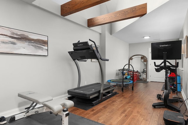 workout room featuring baseboards and hardwood / wood-style floors