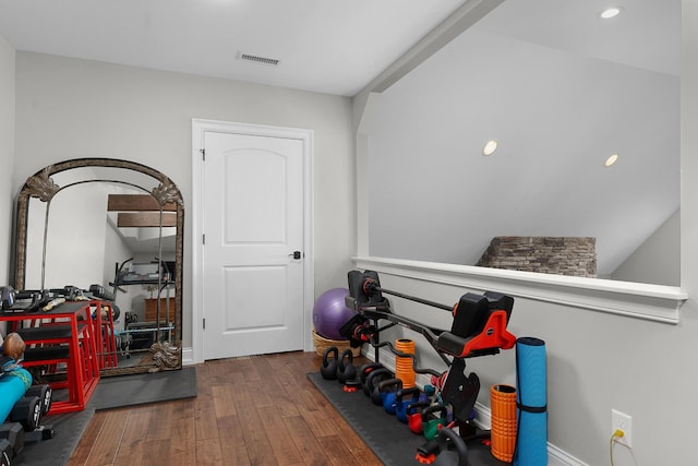workout room featuring wood-type flooring, recessed lighting, and visible vents