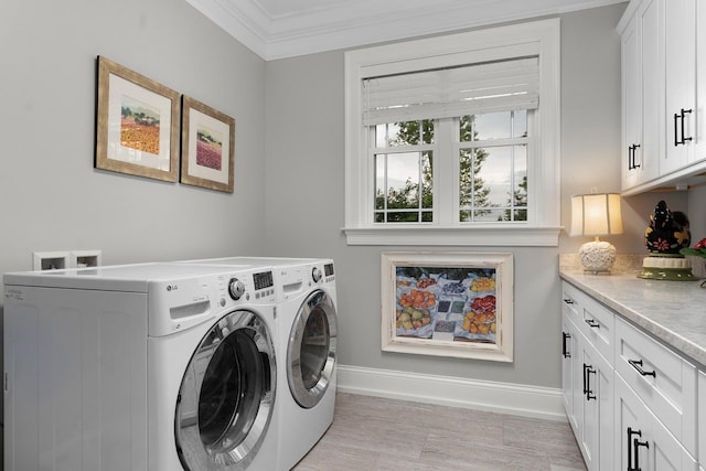 washroom with baseboards, ornamental molding, cabinet space, and independent washer and dryer
