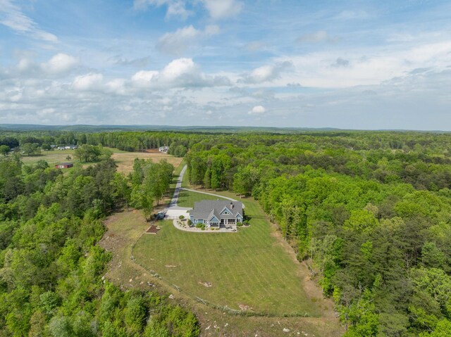 birds eye view of property featuring a rural view and a forest view