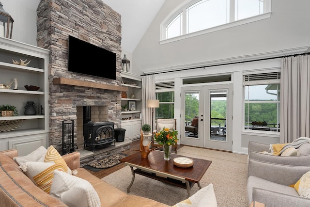 living area featuring french doors, high vaulted ceiling, a wood stove, and built in shelves