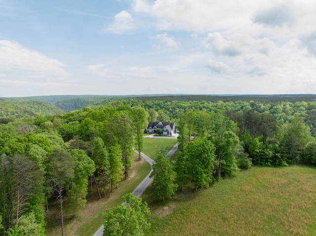 drone / aerial view featuring a view of trees