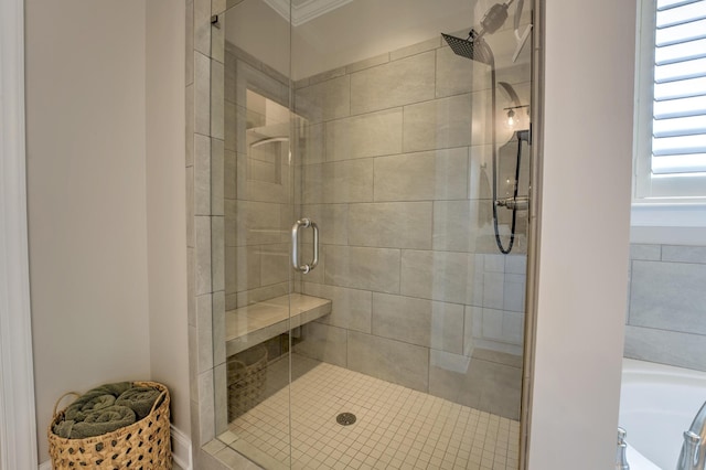 bathroom with crown molding, a garden tub, and a shower stall