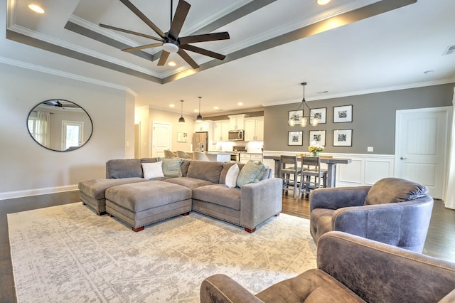 living area featuring a ceiling fan, recessed lighting, crown molding, and wood finished floors