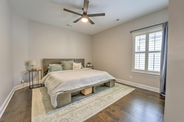 bedroom featuring visible vents, baseboards, ceiling fan, and dark wood-style floors