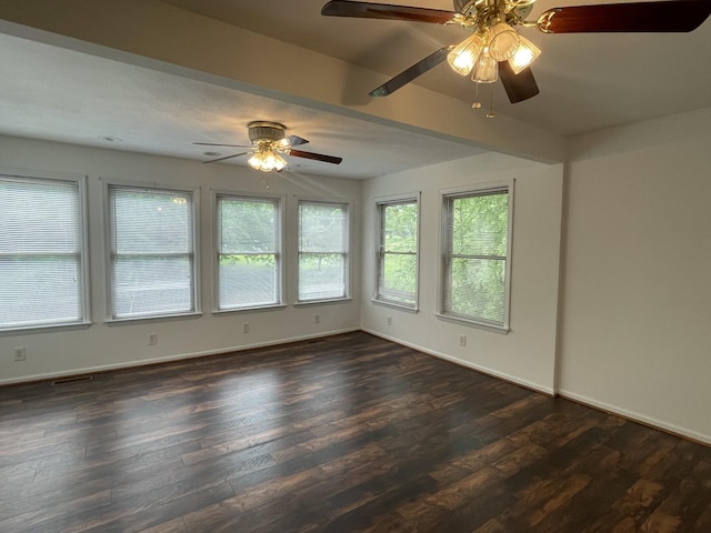 empty room featuring baseboards, a ceiling fan, and dark wood-style flooring