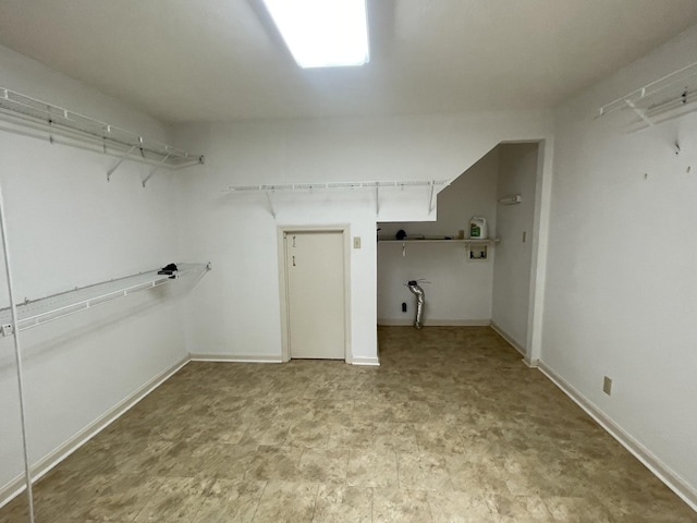walk in closet featuring light floors