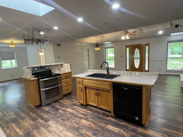 kitchen featuring a sink, an island with sink, dishwasher, and double oven range