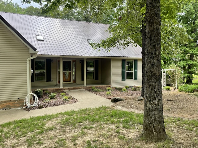 view of front of house featuring covered porch and metal roof