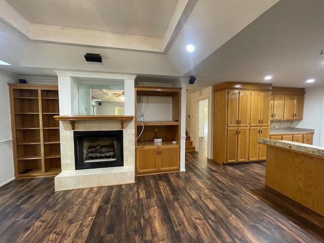 unfurnished living room featuring recessed lighting, dark wood-style floors, and a fireplace