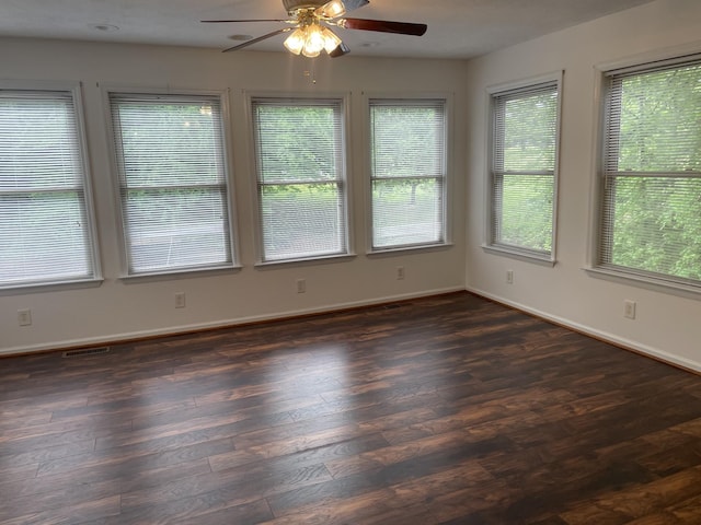 spare room featuring visible vents, a ceiling fan, and plenty of natural light