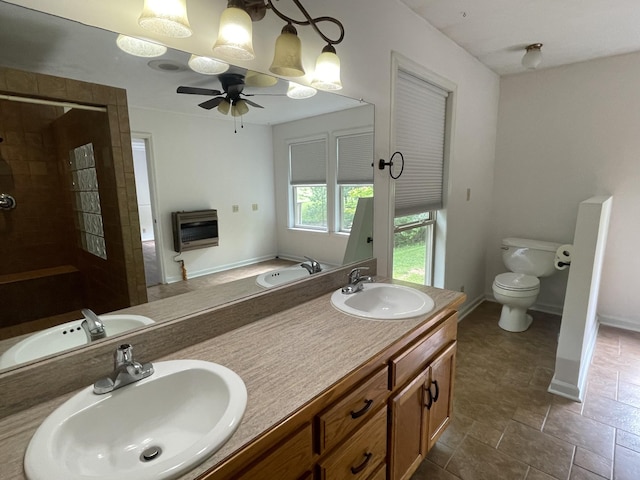 bathroom with heating unit, a tile shower, and a sink