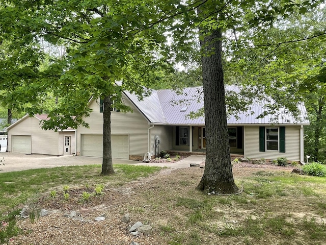 view of front of property featuring metal roof and a garage