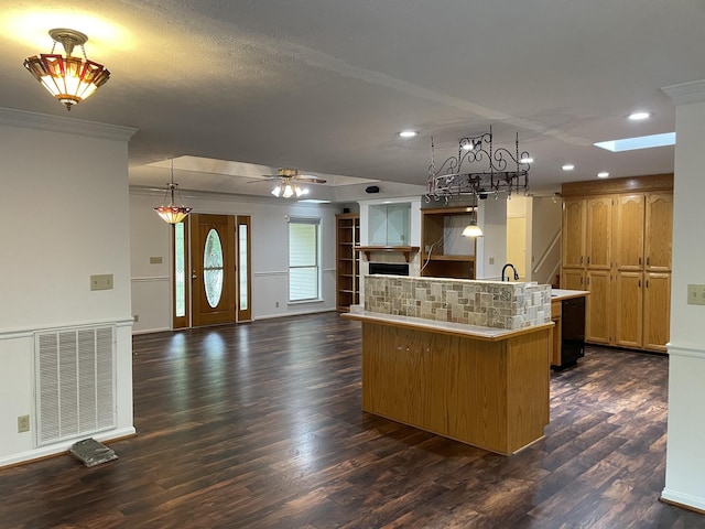 kitchen featuring visible vents, an island with sink, recessed lighting, dark wood-type flooring, and a skylight