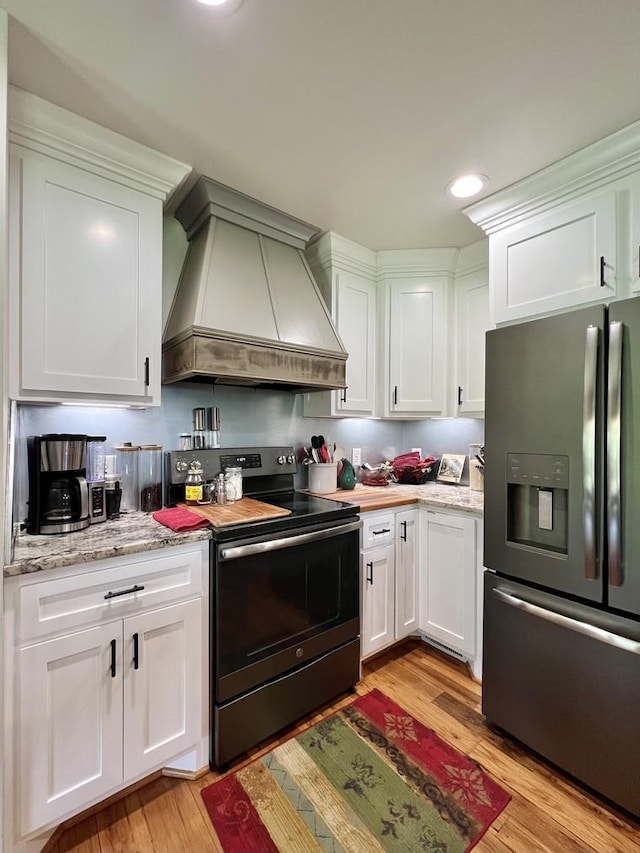 kitchen with range with electric cooktop, custom exhaust hood, light wood finished floors, and stainless steel fridge with ice dispenser