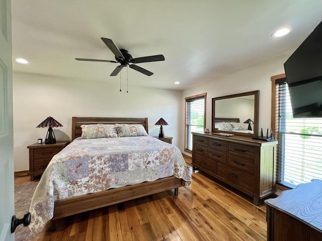 bedroom with recessed lighting, ceiling fan, and light wood-style floors