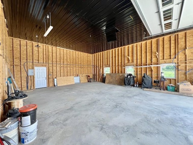 misc room with a garage and concrete flooring