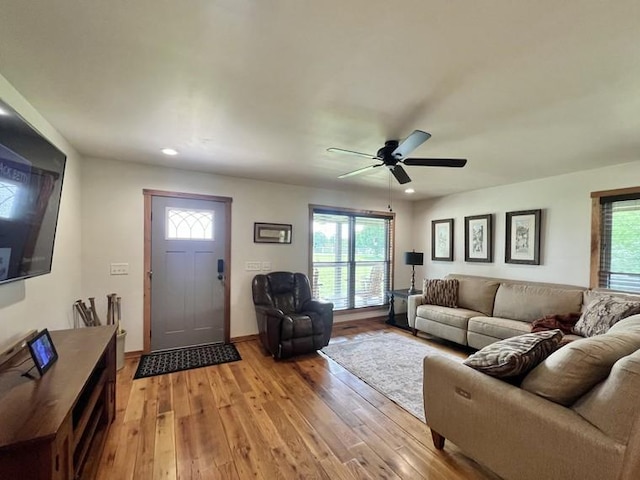 living room featuring recessed lighting, a wealth of natural light, and light wood-style flooring