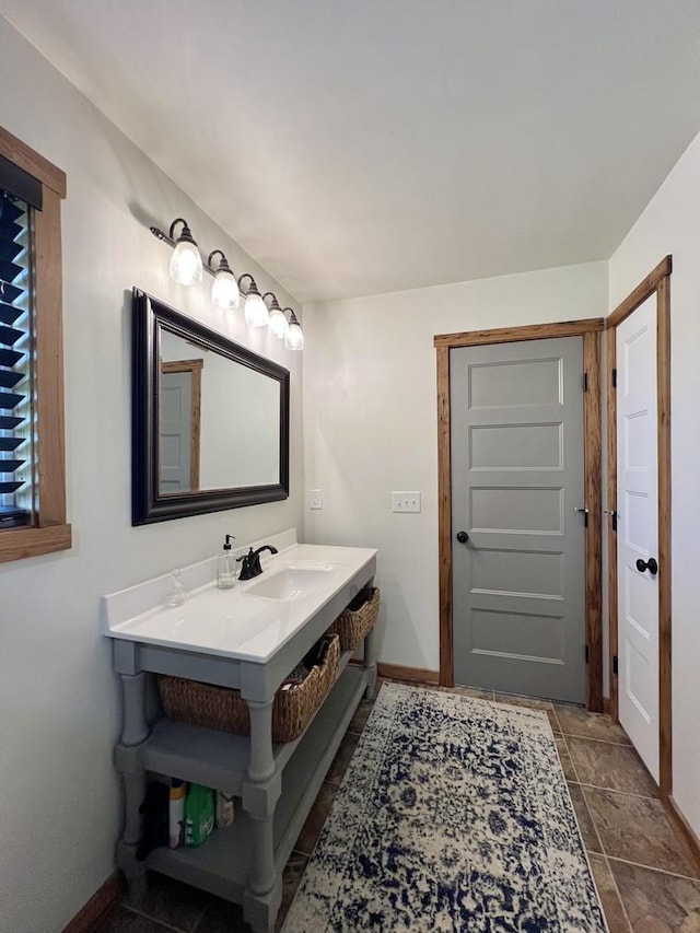 bathroom with baseboards and a sink