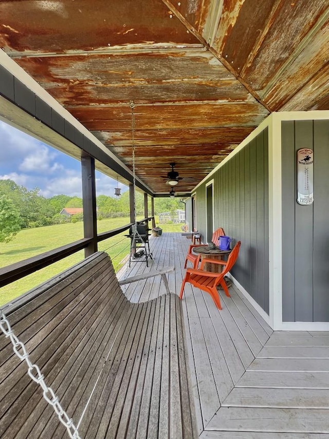 wooden terrace featuring ceiling fan