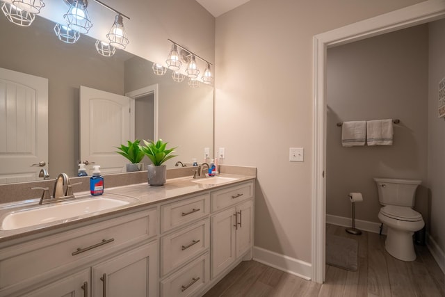 217 Rockhouse Rd, Hohenwald, TN 38462 - full bathroom with a sink, baseboards, toilet, and wood finished floors