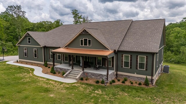 217 Rockhouse Rd, Hohenwald, TN 38462 - rear view of house with a lawn, a shingled roof, a patio area, and cooling unit