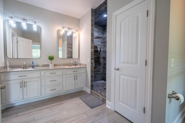 217 Rockhouse Rd, Hohenwald, TN 38462 - full bath with double vanity, a tile shower, a sink, and wood finished floors