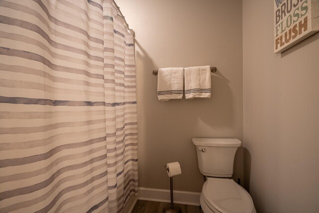 217 Rockhouse Rd, Hohenwald, TN 38462 - full bath featuring baseboards, a shower with curtain, toilet, and wood finished floors