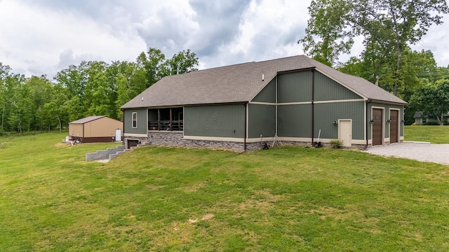 217 Rockhouse Rd, Hohenwald, TN 38462 - rear view of house with a lawn, an outbuilding, and gravel driveway