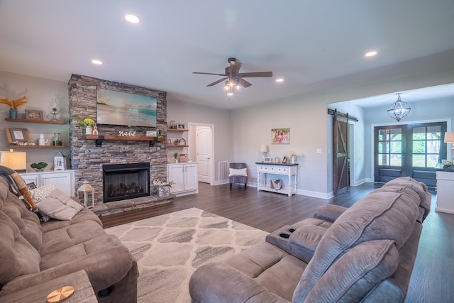 217 Rockhouse Rd, Hohenwald, TN 38462 - living room featuring a ceiling fan, a stone fireplace, visible vents, recessed lighting, and dark wood-type flooring