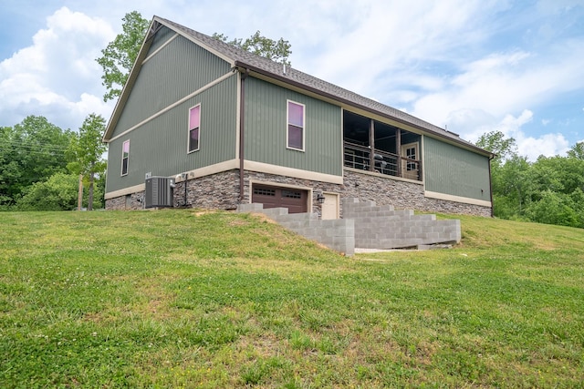 217 Rockhouse Rd, Hohenwald, TN 38462 - view of side of home with central AC unit, an attached garage, a yard, and stone siding