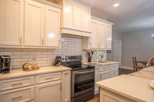 217 Rockhouse Rd, Hohenwald, TN 38462 - kitchen featuring stainless steel electric range, a sink, light countertops, baseboards, and backsplash