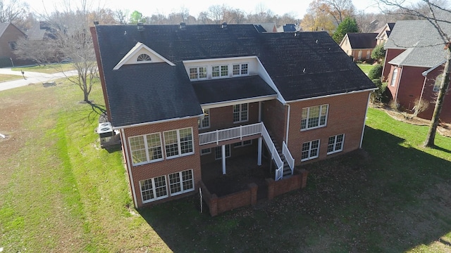 309 New Kent Ct, Tullahoma, TN 37388 - back of house with a lawn, a wooden deck, roof with shingles, and brick siding
