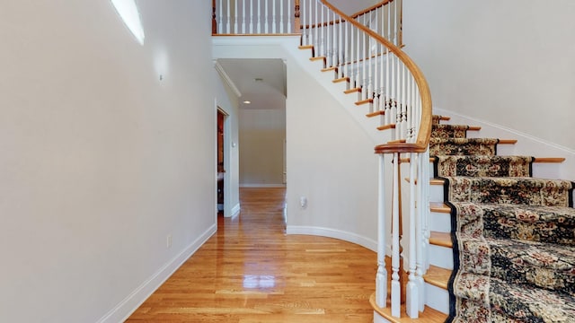 309 New Kent Ct, Tullahoma, TN 37388 - stairs with baseboards, a high ceiling, and wood finished floors