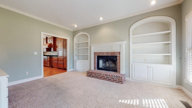 309 New Kent Ct, Tullahoma, TN 37388 - unfurnished living room featuring crown molding, built in features, a brick fireplace, baseboards, and light colored carpet