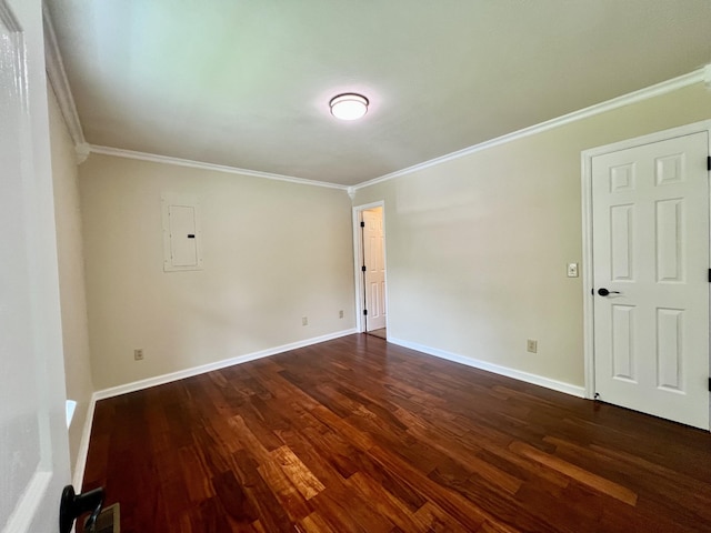 unfurnished room with baseboards, ornamental molding, dark wood-type flooring, and electric panel