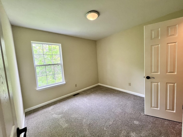carpeted empty room with baseboards and visible vents