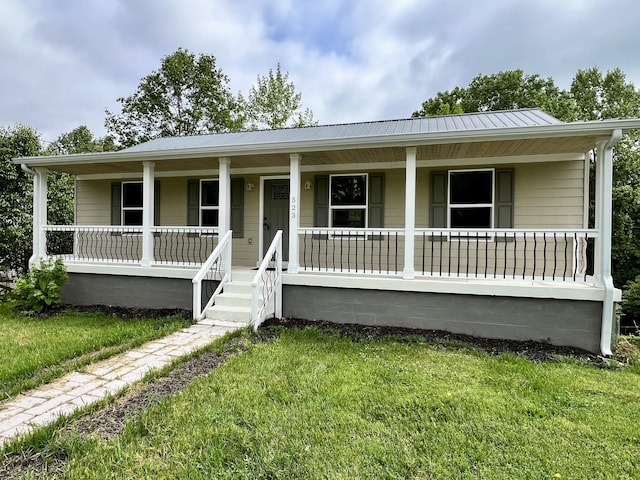 view of front of property with a front lawn, a porch, and metal roof