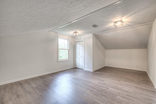 601 Foxborough Sq W, Brentwood, TN 37027 - additional living space with lofted ceiling, baseboards, a textured ceiling, and wood finished floors